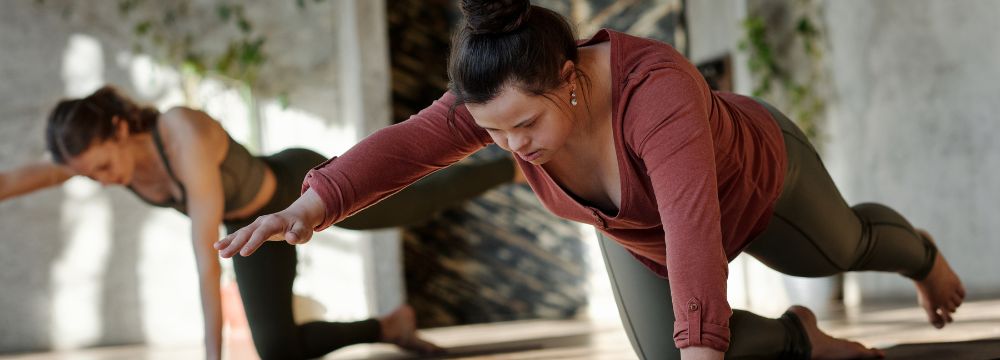 Woman holding yoga pose on floor