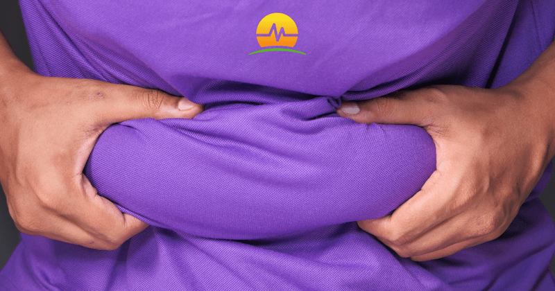 Male in Purple Shirt Grabbing Extra Stomach Weight