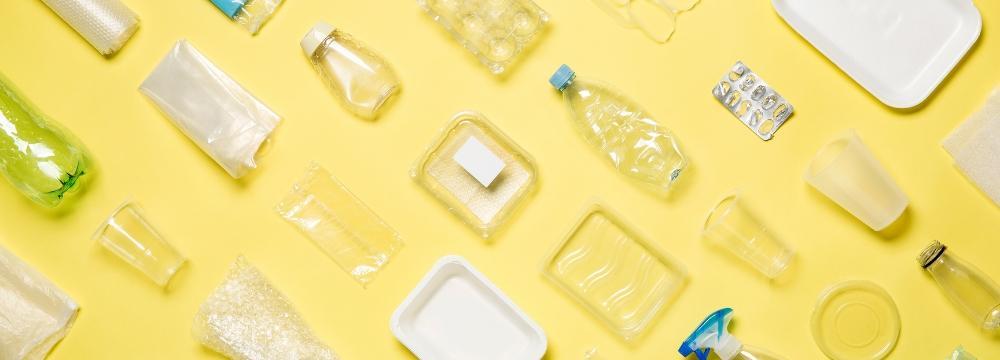 Array of products containing forever chemicals lined up on yellow backdrop