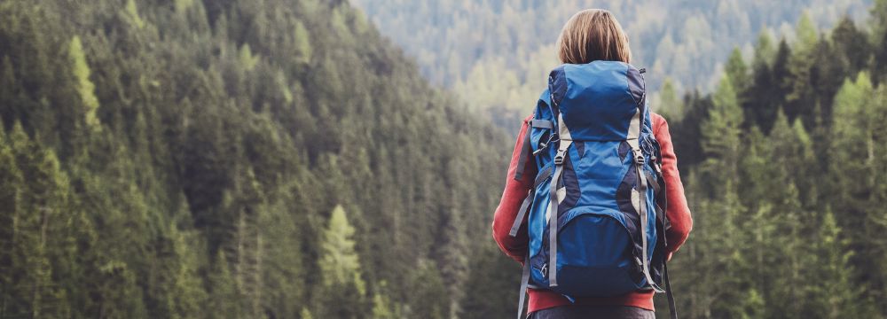 Woman in hiking outfit staring at mountains