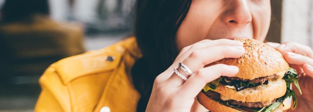 Woman biting into a burger