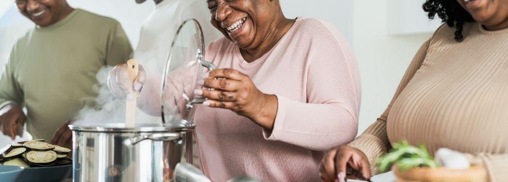 Grandmother prepares a healthy meal with her daughter and grandsons to promote healthy habits with the whole family after her bariatric surgery at MASJax in Jacksonville, FL 