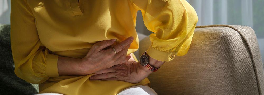 woman holds her abdomen hoping she can avoid hernia surgery with recommendations from a hernia expert