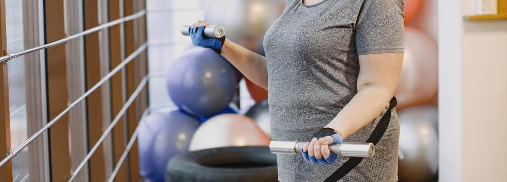 Woman exercising in a workout room lifting weights